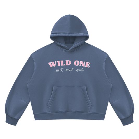 Wild Ones vintage wash hoodie in washed blue, front with arched pink WILD ONE lettering over three hand-drawn running foxes